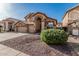 Two-story home featuring a three-car garage, neutral color scheme, mature landscaping, and a concrete driveway at 13750 W Roanoke Ave, Goodyear, AZ 85395