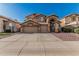 Two-story home featuring a three-car garage, neutral color scheme, desert landscaping, and a concrete driveway at 13750 W Roanoke Ave, Goodyear, AZ 85395