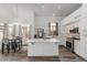 Well-lit kitchen boasting stainless steel appliances, a center island, and a view of the adjacent dining area at 13750 W Roanoke Ave, Goodyear, AZ 85395