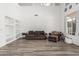 Bright living room with wood-look floors, built-in shelves, neutral paint, and minimalistic decor at 13750 W Roanoke Ave, Goodyear, AZ 85395