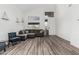 Spacious living room with a high ceiling, modern furniture, many windows, and wood-look flooring at 13750 W Roanoke Ave, Goodyear, AZ 85395
