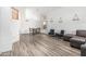 Bright living room with wood-look floors, an adjacent dining area, white walls, and neutral furnishings at 13750 W Roanoke Ave, Goodyear, AZ 85395