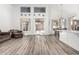 Bright, open living room with vaulted ceilings, wood floors, and seamless access to the outdoor patio at 13750 W Roanoke Ave, Goodyear, AZ 85395