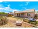 Spacious backyard with covered patio, fire pit and potential for outdoor activities on a sunny day at 16240 W Maricopa St, Goodyear, AZ 85338