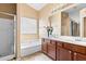 Bathroom features a double sink vanity, soaking tub and shower with a window view at 16240 W Maricopa St, Goodyear, AZ 85338