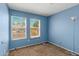 Sunny bedroom with two windows, providing natural light and a serene atmosphere at 16240 W Maricopa St, Goodyear, AZ 85338