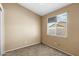 Empty bedroom with window offering natural light and cozy space for relaxation at 16240 W Maricopa St, Goodyear, AZ 85338