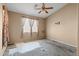 Bedroom with ceiling fan and window providing natural light, ready for updates at 16240 W Maricopa St, Goodyear, AZ 85338
