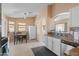 Bright kitchen and dining area with tile flooring and a view into the adjacent living area at 16240 W Maricopa St, Goodyear, AZ 85338