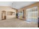 Open living room with a ceiling fan and bright windows, offering plenty of light and a cozy feel at 16240 W Maricopa St, Goodyear, AZ 85338
