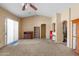 Large living room featuring neutral carpet, vaulted ceilings, and plenty of natural light at 16240 W Maricopa St, Goodyear, AZ 85338