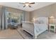 Serene primary bedroom with large window, plush carpeting, a comfortable bed, and calm, neutral color scheme at 18023 W Statler St, Surprise, AZ 85388
