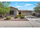 Charming single story home with desert landscaping, tan exterior, and a two car garage at 18023 W Statler St, Surprise, AZ 85388