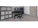 Functional home office featuring a sleek black desk and shelving units for optimal organization and storage at 18023 W Statler St, Surprise, AZ 85388