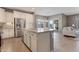 Beautiful kitchen island with stainless steel appliances opens to the ajoining living area with large sliding glass door at 18023 W Statler St, Surprise, AZ 85388