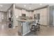 Bright kitchen features white cabinets, stainless steel appliances, and a large island with bar seating at 18023 W Statler St, Surprise, AZ 85388