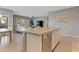 The open-concept kitchen features a large island, stainless steel appliances, and seamless flow to the living area at 18023 W Statler St, Surprise, AZ 85388