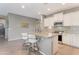 Bright kitchen featuring a granite countertop island with seating and tile floors at 18023 W Statler St, Surprise, AZ 85388