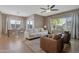 Well-lit living room features a neutral color palette, comfortable seating arrangement, and an open flow to the dining room at 18023 W Statler St, Surprise, AZ 85388