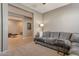 Inviting living room with carpet, a large sofa, and neutral wall color at 18023 W Statler St, Surprise, AZ 85388