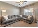 Comfortable living room featuring a large sectional sofa and neutral colored walls at 18023 W Statler St, Surprise, AZ 85388