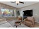 Cozy living room with neutral tones, comfortable seating, and plenty of natural light streaming through the window at 18023 W Statler St, Surprise, AZ 85388