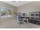 Home office provides natural light, modern furniture, and ample storage for an organized workspace at 18023 W Statler St, Surprise, AZ 85388