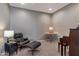 Sitting area with a chair and ottoman and a small table with a table lamp at 18023 W Statler St, Surprise, AZ 85388