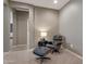 Sitting area with a black chair and ottoman near an entryway and light walls at 18023 W Statler St, Surprise, AZ 85388