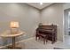 Sitting area featuring a piano and bench, with a table and lamp beside it at 18023 W Statler St, Surprise, AZ 85388