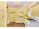 This kitchen features yellow cabinetry, a gas range, and tile countertops at 2308 W Marlette Ave, Phoenix, AZ 85015