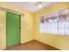 Bright bedroom with window with curtain, and painted concrete floors at 2308 W Marlette Ave, Phoenix, AZ 85015