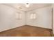 Empty bedroom with two windows and neutral walls with minimal design at 2308 W Marlette Ave, Phoenix, AZ 85015