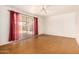 Spacious living room with sliding glass door, ceiling fan, and polished concrete floors at 2308 W Marlette Ave, Phoenix, AZ 85015