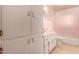 Bathroom with pink countertops and built in cabinets at 2308 W Marlette Ave, Phoenix, AZ 85015