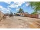 Picture of a wide open dirt backyard with playset, adjacent to a well-maintained house at 2308 W Marlette Ave, Phoenix, AZ 85015