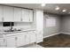 Bright, updated kitchen with white cabinets and marble-look countertops with adjoining dining area at 29 W Southern Ave # 28, Mesa, AZ 85210