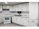 Well-lit kitchen featuring white cabinets, an electric stove, and marble-look countertops at 29 W Southern Ave # 28, Mesa, AZ 85210