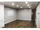 Spacious living room featuring modern recessed lighting, wood-look floors, and neutral gray walls at 29 W Southern Ave # 28, Mesa, AZ 85210