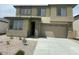Two-story home with a two car garage, landscaped front yard, and neutral color palette at 37568 W Patterson St, Maricopa, AZ 85138