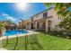 Expansive backyard showcasing a shimmering pool, lush landscaping, and covered patio area, perfect for outdoor living at 45247 W Jack Rabbit Trl, Maricopa, AZ 85139