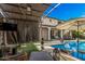 Inviting backyard featuring a beautiful pool, comfortable seating, and a shaded patio, creating a relaxing outdoor space at 45247 W Jack Rabbit Trl, Maricopa, AZ 85139