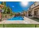 Spacious backyard with a refreshing pool, covered patio, and mature trees, ideal for Gathering gatherings and outdoor enjoyment at 45247 W Jack Rabbit Trl, Maricopa, AZ 85139