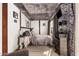 Unique bedroom with exposed beams, seating area, and access to a cozy outdoor space at 45247 W Jack Rabbit Trl, Maricopa, AZ 85139