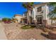Two-story home with desert landscaping and a palm tree in front at 45247 W Jack Rabbit Trl, Maricopa, AZ 85139