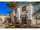 Two-story home with desert landscaping and a palm tree in front at 45247 W Jack Rabbit Trl, Maricopa, AZ 85139