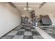 Spacious garage with black and gray checkered flooring and plenty of storage space at 45247 W Jack Rabbit Trl, Maricopa, AZ 85139