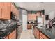 Modern kitchen with stainless steel appliances, granite countertops, and stylish backsplash at 45247 W Jack Rabbit Trl, Maricopa, AZ 85139