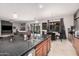 Open kitchen with granite counters, double sinks, and a view into the dining and living area at 45247 W Jack Rabbit Trl, Maricopa, AZ 85139