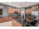 Beautiful kitchen featuring granite counters, stainless steel appliances, and a large island at 45247 W Jack Rabbit Trl, Maricopa, AZ 85139